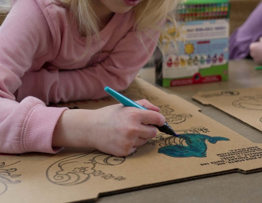 Kid coloring a cartoon character on a Hobie Kit kids play fort.