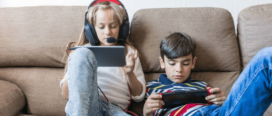 Boy and girl playing with electronics.