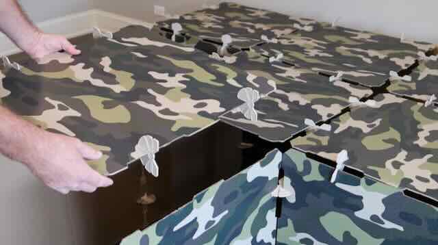 A camouflage printed kids play fort roof panel being installed on a fort kit.