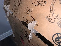 Kidz Forts white plastic fort connectors securing cardboard fort panels with printed designs.