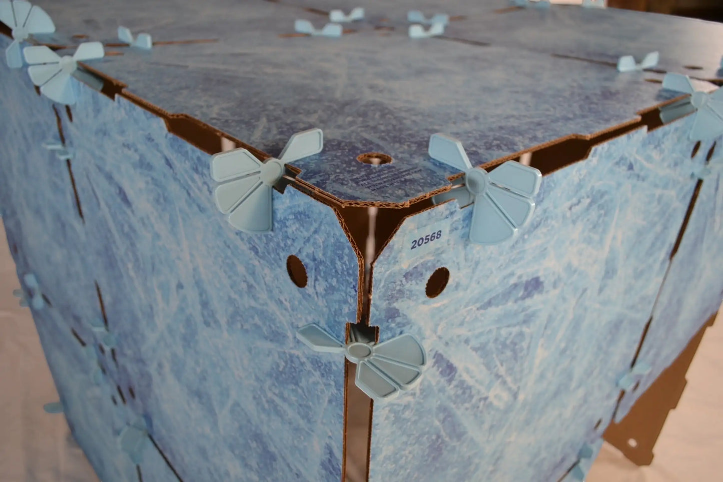 Kidz Forts Frosted Kit assembled play fort showing icy blue cardboard panels connected with twist-lock connectors.
