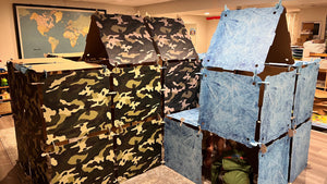 Two Kidz Forts, one being a Commando Kit, camouflage-patterned and one being a Frosted Kit with a frozen icy theme in an indoor setting.