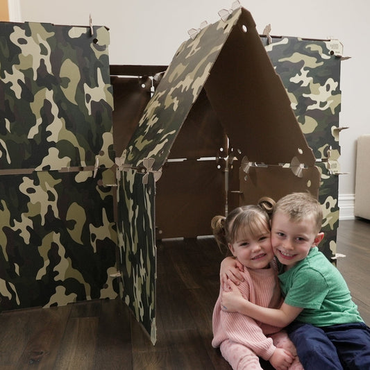 Kidz Forts Commando camouflage play fort kit made of durable cardboard with twist-lock connectors. Two children hug in front.